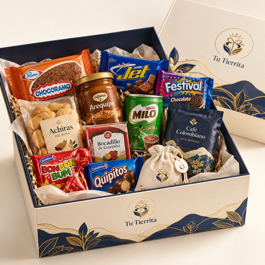 Caja Nostalgia abierta con chocolatinas, galletas, arequipe, bocadillo y café